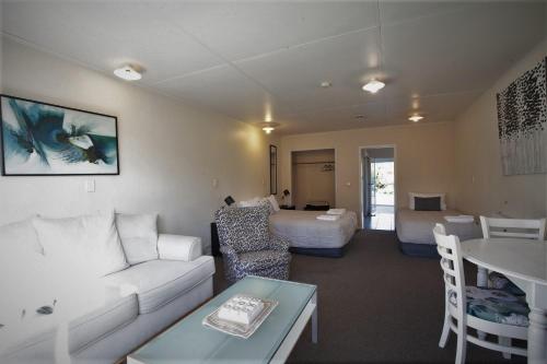 a living room with a couch and a table at Golden Bay Motel in Takaka