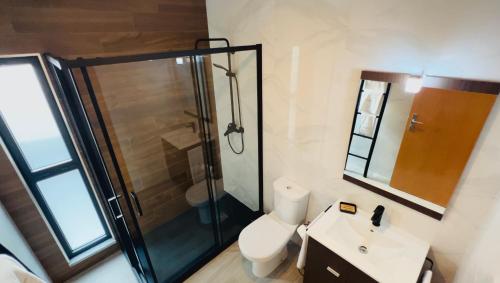 ein Badezimmer mit Dusche, Toilette und Waschbecken in der Unterkunft School Motorhome Park in Óvoa