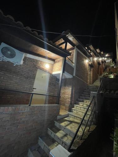 a set of stairs leading to a building at night at Hotel Kappa3 Villas in Vlorë