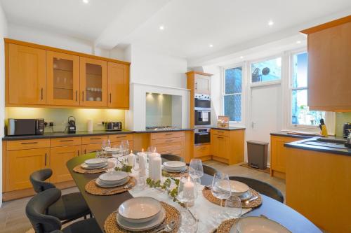 a kitchen with a table with dishes on it at Spacious and Modern 4 beds home in Kensington in London