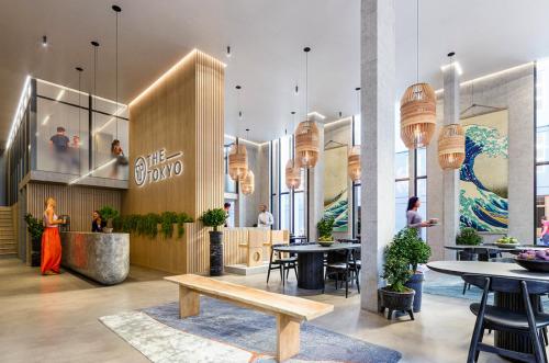 a lobby of a restaurant with tables and chairs at THE TOKYO in Cape Town