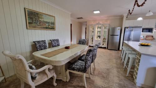 a kitchen and dining room with a table and chairs at Spacious Holiday Home - Waikerie in Waikerie