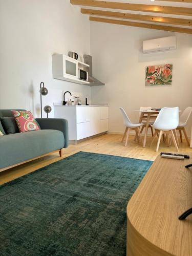 a living room with a couch and a table at Horta dos Cedros in Tomar
