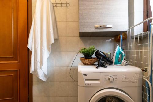 a kitchen with a washing machine in a bathroom at SMART FLAT - Lago Maggiore - Private Garage, Wi-Fi in Castelletto sopra Ticino