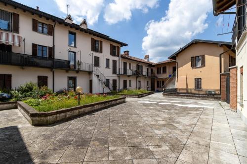 a row of buildings with a courtyard at SMART FLAT - Lago Maggiore - Private Garage, Wi-Fi in Castelletto sopra Ticino