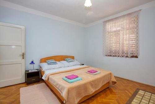 a bedroom with a bed with two towels on it at Apartments by the sea Tisno, Murter - 21405 in Tisno