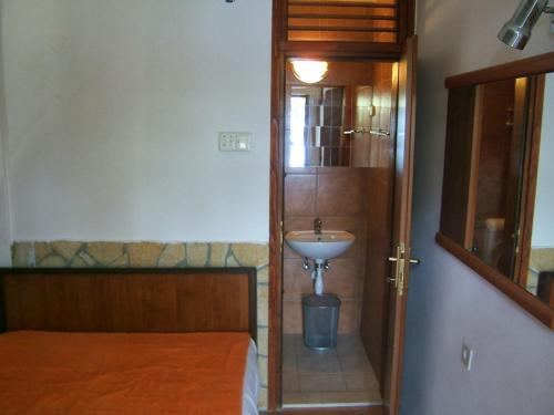 a small bathroom with a sink and a mirror at Apartments by the sea Podaca, Makarska - 19078 in Podaca