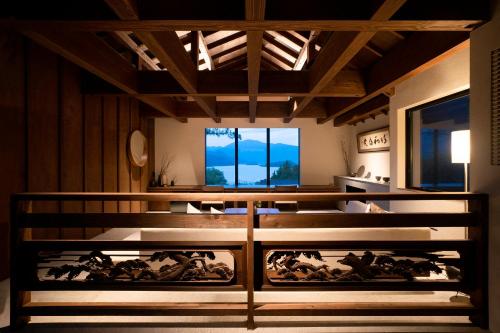 a room with a group of horses on the wall at 湖畔を一望するプライベートホテル / THE [] TIME FUJI in Fujikawaguchiko