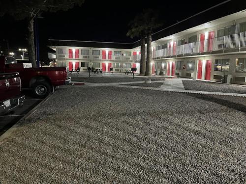 a truck parked in front of a building at night at Rodeo Inn in Pecos