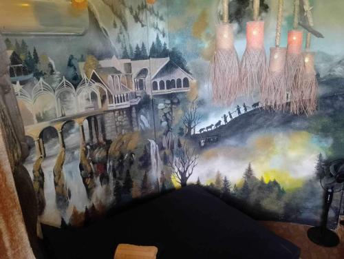 a wall with a painting of a castle at Sanctuaria Treehouses Busuanga in Busuanga