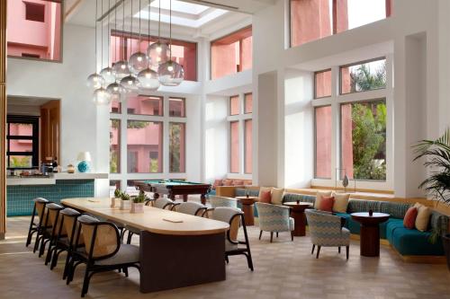 a restaurant with tables and chairs and windows at The Ritz-Carlton Tenerife, Abama in Guía de Isora