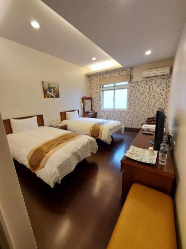Postel nebo postele na pokoji v ubytování Xinhe Homestay