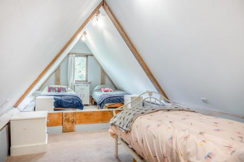 a bedroom with two beds in a attic at Elms Barn in Saint James