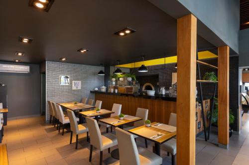 a dining room with wooden tables and chairs at Best Western Premier Marina Las Condes in Santiago