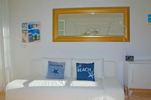 オストゼーバート・ゼリンにあるVilla Baltic 12の白いベッド(鏡、青い枕付)