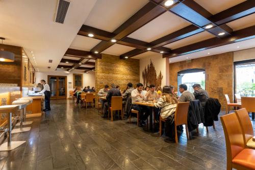 a group of people sitting at tables in a restaurant at Best Western Marina del Rey in Viña del Mar