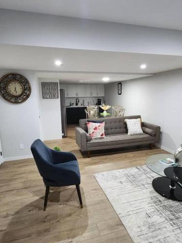 a living room with a couch and a chair at 2-bedroom basement apartment in Calgary