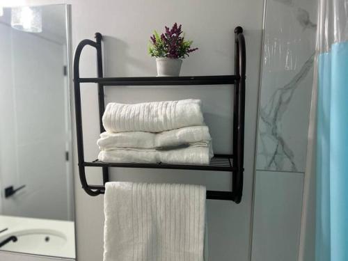 a towel rack with towels on it in a bathroom at 2-bedroom basement apartment in Calgary
