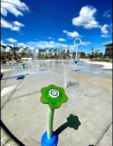 a water fountain in a park with a playground at 2-bedroom basement apartment in Calgary