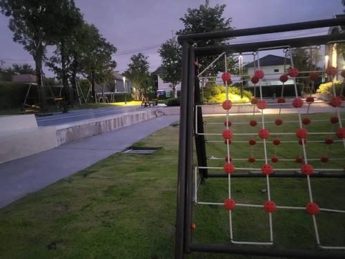 a fence with red balls on it in a park at MOST Family 456/66 Ubon-Thailand in Ubon Ratchathani