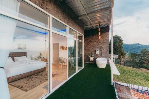 a bedroom with a bed and a tub in a room at ไนท์สกาย โฮมสเตย์ in Ban Mae Na