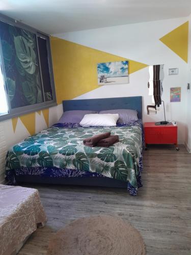 1 dormitorio con 1 cama con colcha colorida en Little Ferry - 3rd floor no elevator en Papeete