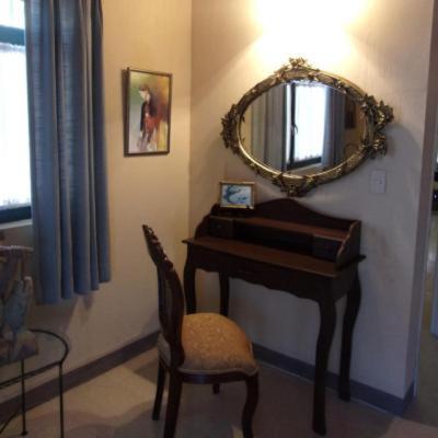 a room with a piano and a mirror and a chair at Casita Montana Hotel in Ajijic