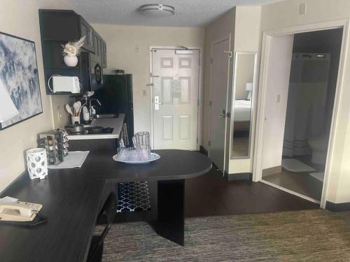 a kitchen with a table and a sink in a room at Ultimate Escape/Free Parking in Houston