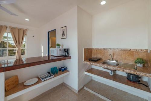 a kitchen with a sink and a counter at Suites Ha in Isla Mujeres