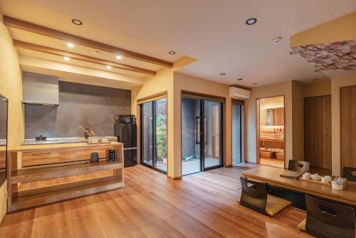 a large kitchen with wooden floors and glass windows at 谷町君 星屋 離宮ノ宿 二条城 in Kyoto