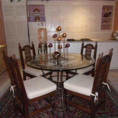 a dining room table with four chairs and a glass table at Casita Montana Hotel in Ajijic