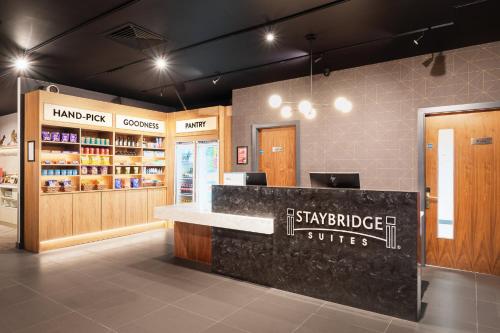 a store with a counter in the middle of a room at Staybridge Suites Brighton by IHG in Brighton & Hove