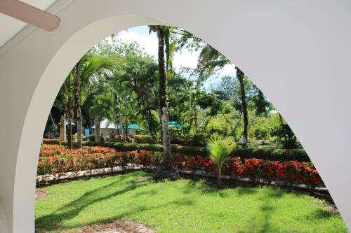 an archway in a park with flowers at Family 2bd apt near Quepos/Manuel Antonio in Quepos