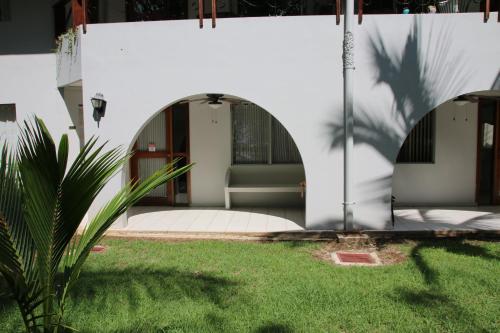 a house with a chair in a yard at Family 2bd apt near Quepos/Manuel Antonio in Quepos