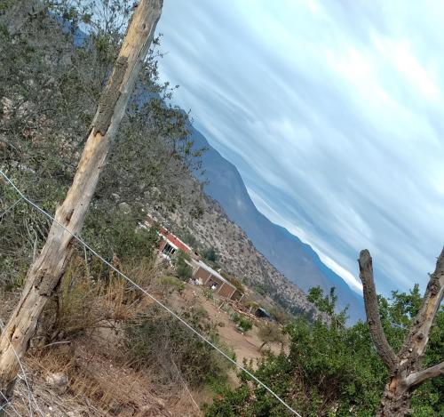a telephone pole with a house on a mountain at Alojamiento Rural Polita, Agroturismo y Patrimonial in Petorca