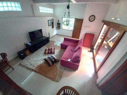 eine Luftansicht auf ein Wohnzimmer mit einer rosa Couch in der Unterkunft Villa Sajodo [Hilltop Get Away w/ Valley View] in Bandung