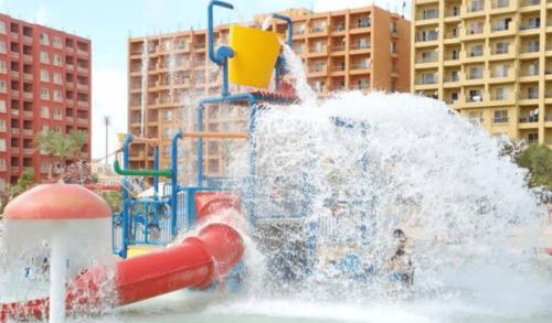 a water park with a water slide in a city at Prime chalet in Golf Porto Marina resort new Alamein in El Alamein