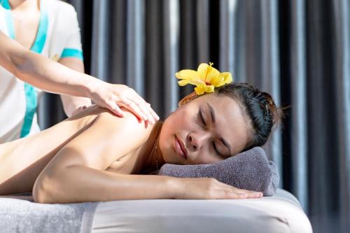 a woman getting a massage from a therapist at Mercury Phu Quoc Resort & Villas in Phu Quoc
