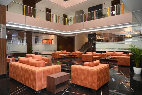 a lobby with couches and tables in a building at Effotel by Sayaji Sarola in Bhor