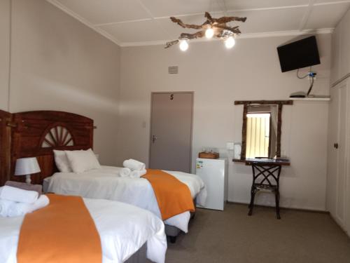 Кровать или кровати в номере Die Windpomp Guesthouse