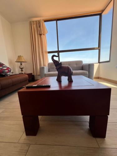 a dog statue sitting on a coffee table in a living room at DEPARTAMENTO 5to piso CON VISTA AL MAR in Playas