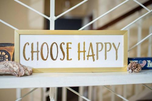 a sign that says choose happy sitting on a shelf at Forget your worries in this serene 5 Bedroom Villa in Ngong in Nairobi
