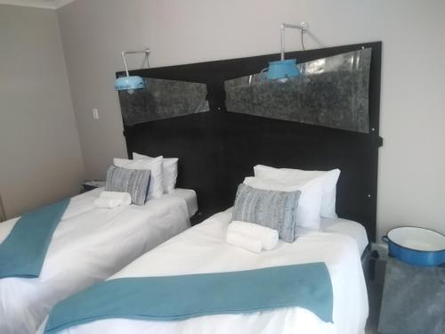 Кровать или кровати в номере Die Windpomp Guesthouse