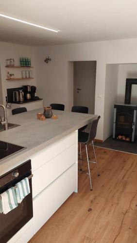 a kitchen with a counter and chairs in a room at Ferienwohnung Sofka in Sekull