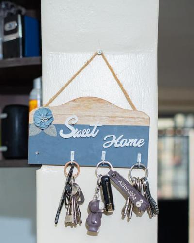 a bunch of keys hanging from a sign on a shelf at Forget your worries in this serene 5 Bedroom Villa in Ngong in Nairobi