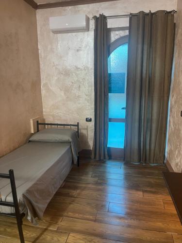 a small bedroom with a bed and a window at The New B&B in Poggio Imperiale
