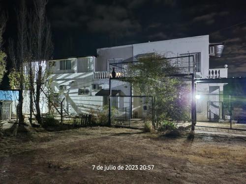 a white building with a person standing on the balcony at Departamentos las chacras in Juana Koslay 