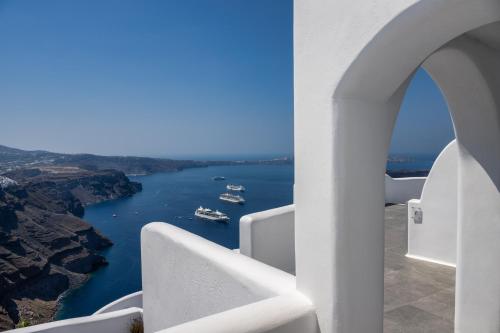 a view of a river from a white building at Eteoro Suites in Imerovigli