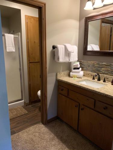 a bathroom with a sink and a mirror at Giant Steps 17 Ski In-out in Brian Head