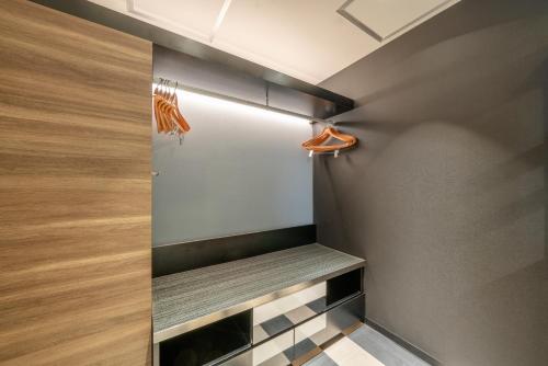 a walk in closet with a bench in a room at New Otani Inn Sapporo in Sapporo